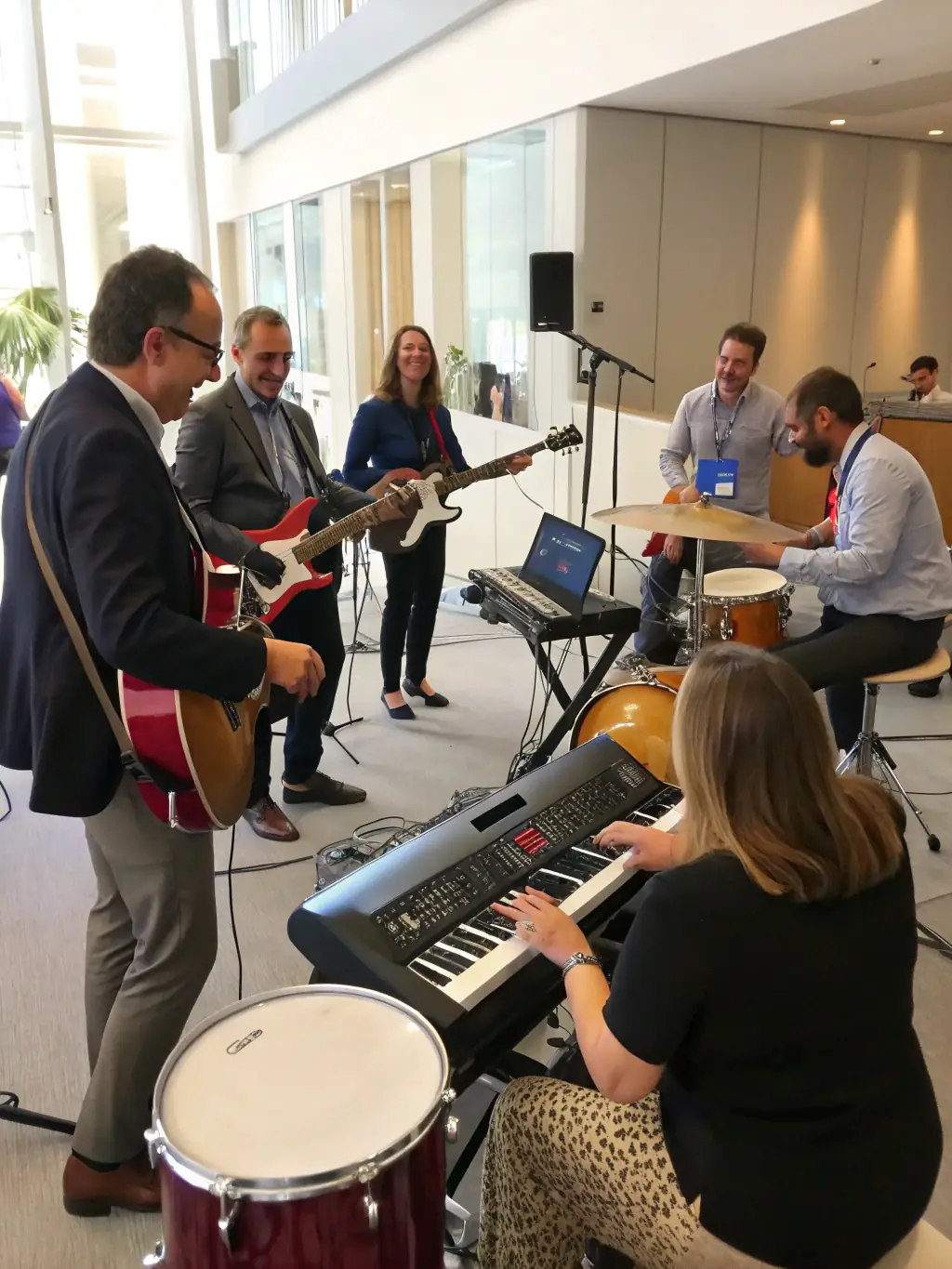 A vibrant image of a diverse group of musicians collaborating during a QUETZAL NELKAEL-sponsored music workshop, showcasing the energy and creativity of the participants.